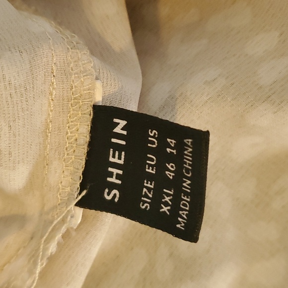 Leopard print, cream colored blouse with flutter sleeve detail. - Picture 2 of 2